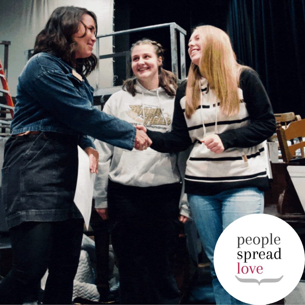 Heather DeVine shakes hands with Teton High School students that granted PSL funding to support The Kindness Fund